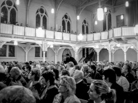 many guests in the church große kreuzkirche in hermannsburg are listening a gospel concert, black-and-white