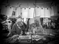 at a festival of the evangelical mission in hermannsburg two older woman rummage in books, black-and-white