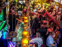 view from above in the papa joe\'s jazzlokal in cologne with many customers and colorful lights
