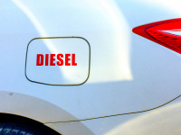 a filler flap of a white rental car on rhodes is a red lettering with diesel