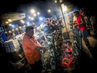 at a funfair in kremasti on rhodes men are grilling meat on a hot grill