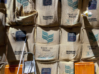 empty jute coffee bags from brasil and rimini are hanging on a wall in the old town of rhodes