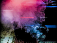 the smoking exhaust of an black bmw e 60