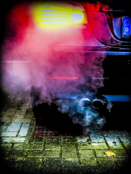 the smoking exhaust of an black bmw e 60