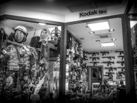 the store window of a gun shop in san marino, black-and-white