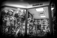 the store window of a gun shop in san marino, black-and-white