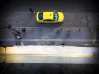 from the balkon of the attalos hotel in athens you see a yellow taxi on the street