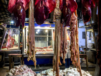 raw offals for a greek kokoretsi are hanging in a hall of the central market in athens