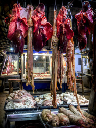 raw offals for a greek kokoretsi are hanging in a hall of the central market in athens