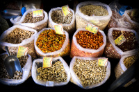 a dozen bags full of various nuts are for sale on the market in aegio