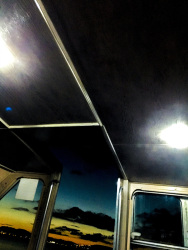 the view from a excursion boat on the lake pamvotida in ioannina to the illuminated city by sunset