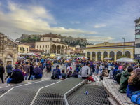 many people at the monastiraki place in athens in evening light