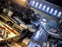 the sellers in the fish hall at the central market in athens just before closing time