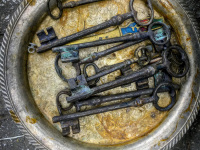 at the antique market in monastiraki laying big old metal keys on a silver plate