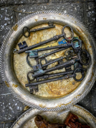 at the antique market in monastiraki laying big old metal keys on a silver plate