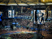 thousand of metal fans and monitors with james hetfield on it in the volksparkstadion in hamburg at the metallica concert