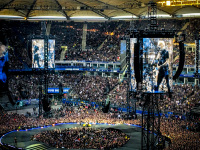 thousand of metal fans and monitors with james hetfield on it in the volksparkstadion in hamburg at the metallica concert