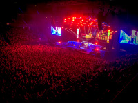 thousands of metal fans and a colorful stage with iron maiden at a concert in expo plaza in hannover