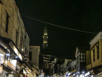illuminated shops and many tourists by night in the socrates street in rhodes city