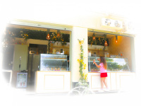 at a full with flowers decorated icecream parlor a girl is buying icecream