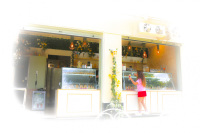 at a full with flowers decorated icecream parlor a girl is buying icecream