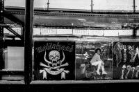 the shop window of a shop with old lp\'s in athens shows motörhead, whitney houston and prince, black-and-white