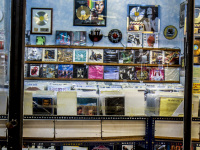 view throuhg a window in a shop with old lp\'s in monastiraki in athens