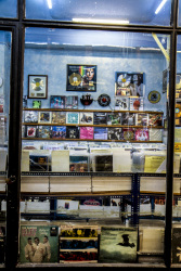 view throuhg a window in a shop with old lp\'s in monastiraki in athens