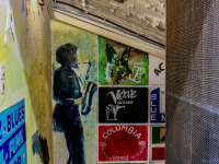 the entrance to a shop with old lp\'s in monastiraki in athens is full of colorful pictures