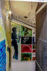 the entrance to a shop with old lp\'s in monastiraki in athens is full of colorful pictures