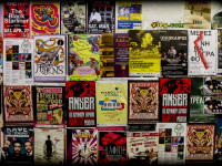 a wall full of colorful posters of concerts and festivals in a passage in monastiraki in athens