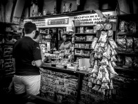customers are waiting at a greek kiosk in rhodes city, where many stuff is hanging
