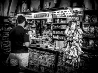 customers are waiting at a greek kiosk in rhodes city, where many stuff is hanging