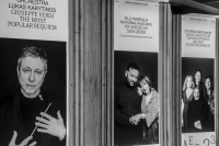 three big placards with greek musicians are hanging in front of the herodes atticus theatre near the acropolis in athens, black-and-white