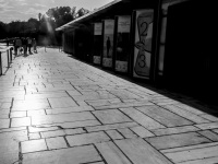 on the way next to culture placards which are standing in front of the herodes atticus theatre near the acropolis in athens, black-and-white