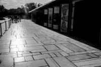 on the way next to culture placards which are standing in front of the herodes atticus theatre near the acropolis in athens, black-and-white