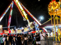 on a funfair in kremasti on rhodes young people are going passs carousels