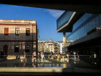 guests are leaving the acropolis museum in athens at a loveley evening light and a blue sky