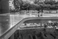 the entrance of the acropolis museum in athens with the lower and the upper area and with some tourists, black-and-white