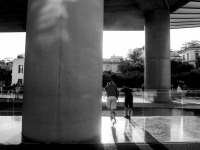 the entrance of the acropolis museum athens with big columns and people in the backlight, black-and-white
