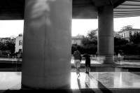 the entrance of the acropolis museum athens with big columns and people in the backlight, black-and-white
