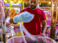 on a funfair in kremasti on rhodes a men is making blue cotton candy