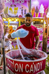 on a funfair in kremasti on rhodes a men is making blue cotton candy