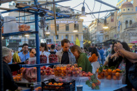customers at a fruit stand at the monastiraki square in athenswith fresh peaches, aprictos, oranges and cherries