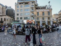 young people in a evening light on the monastiraki square in athens
