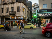 traffic with cars, taxis, motocycles and pedestrians on the street next to the monastiraki square in athens