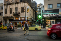 traffic with cars, taxis, motocycles and pedestrians on the street next to the monastiraki square in athens