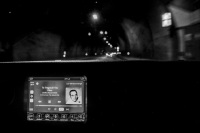 view out of a car in tunnel near gavrolimni, in front the navi shows that the tape is playing music of stelios kazantzidis, black-and-white