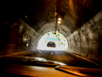 view out of a jeep wrangler in a tunnel near metsovo with light at the end of the tunnel