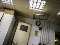 view from a stretcher in a hospital room in aegio in greece on a door, a clock and a saint icon